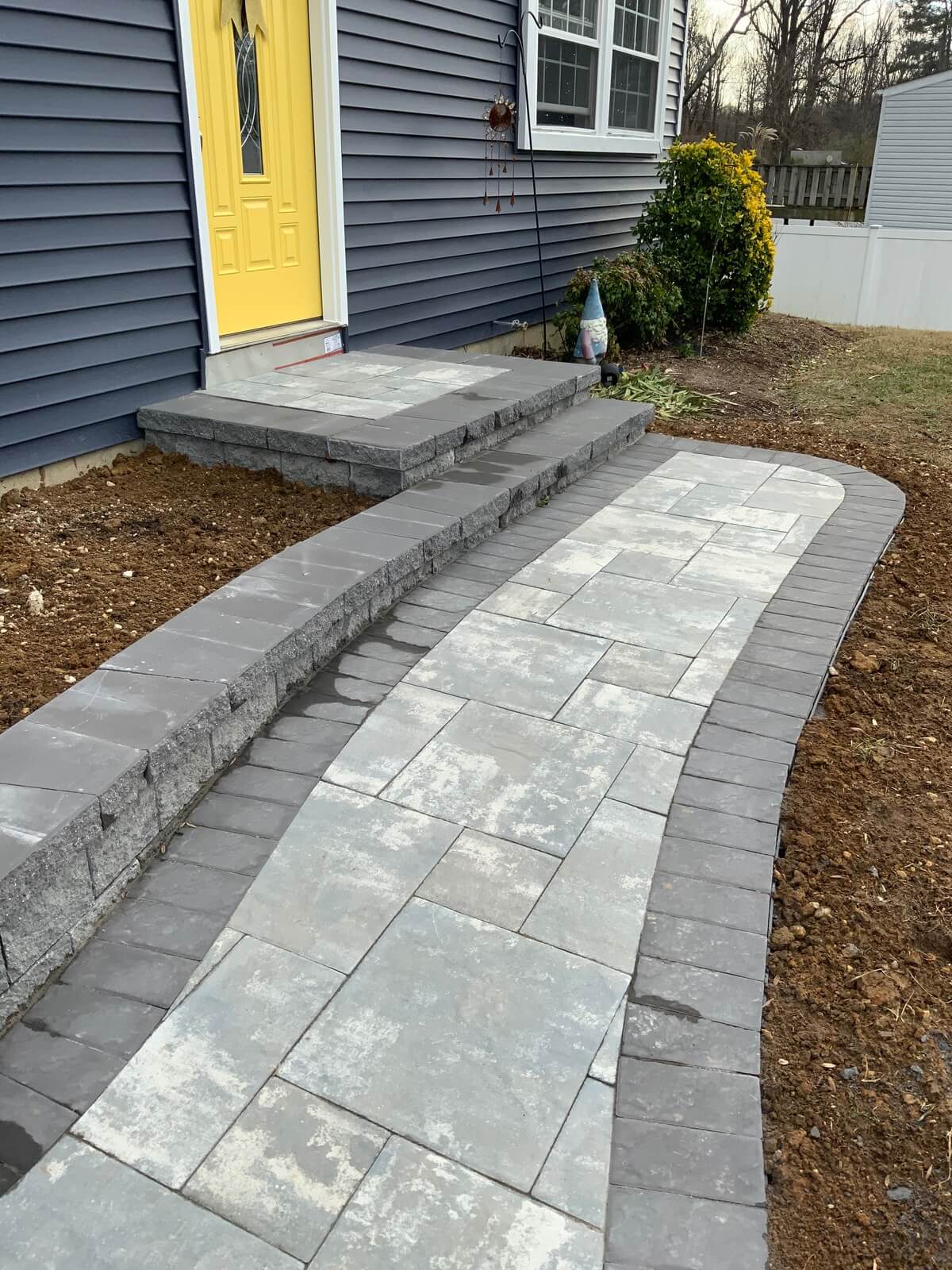 Walkway and new vinyl siding for Maryland home.