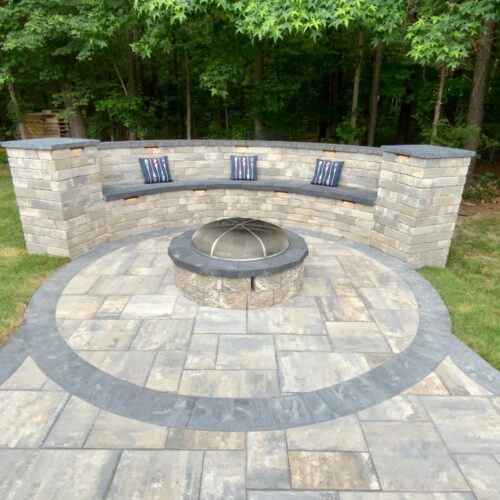 Wood fire pit and paver bench.